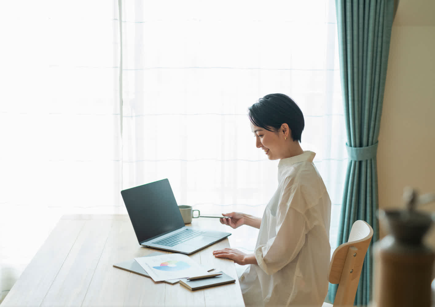 Woman working from home behind a laptop.