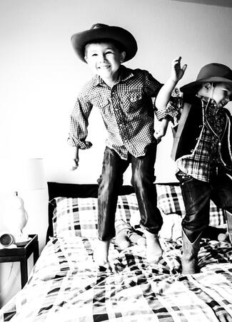 Visio Lending Customer Image: Children playing on a bed