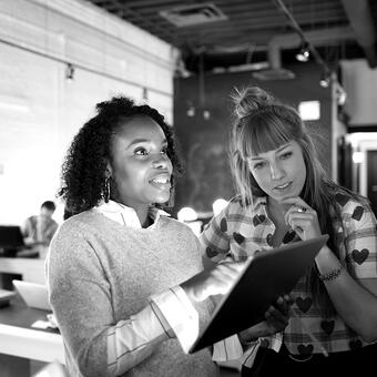 Woman holding tablet and having a discussion in the office