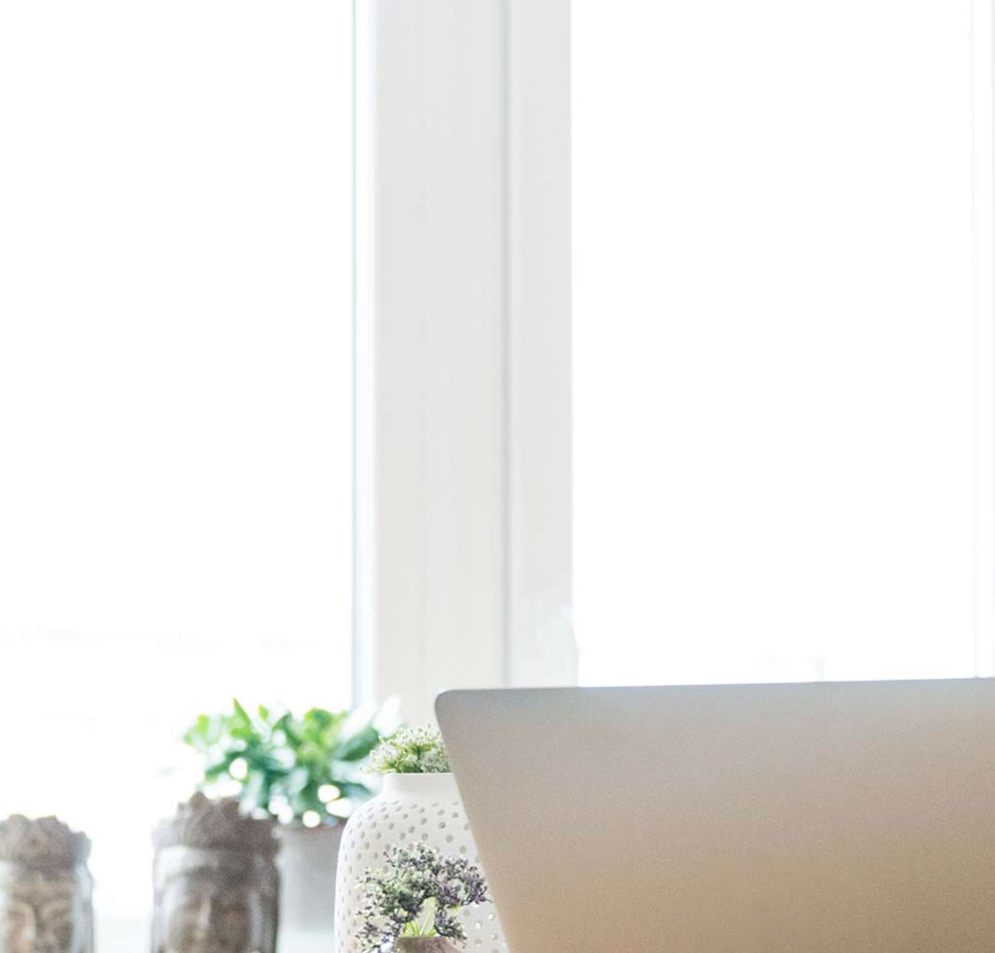 Woman working on computer from home office.