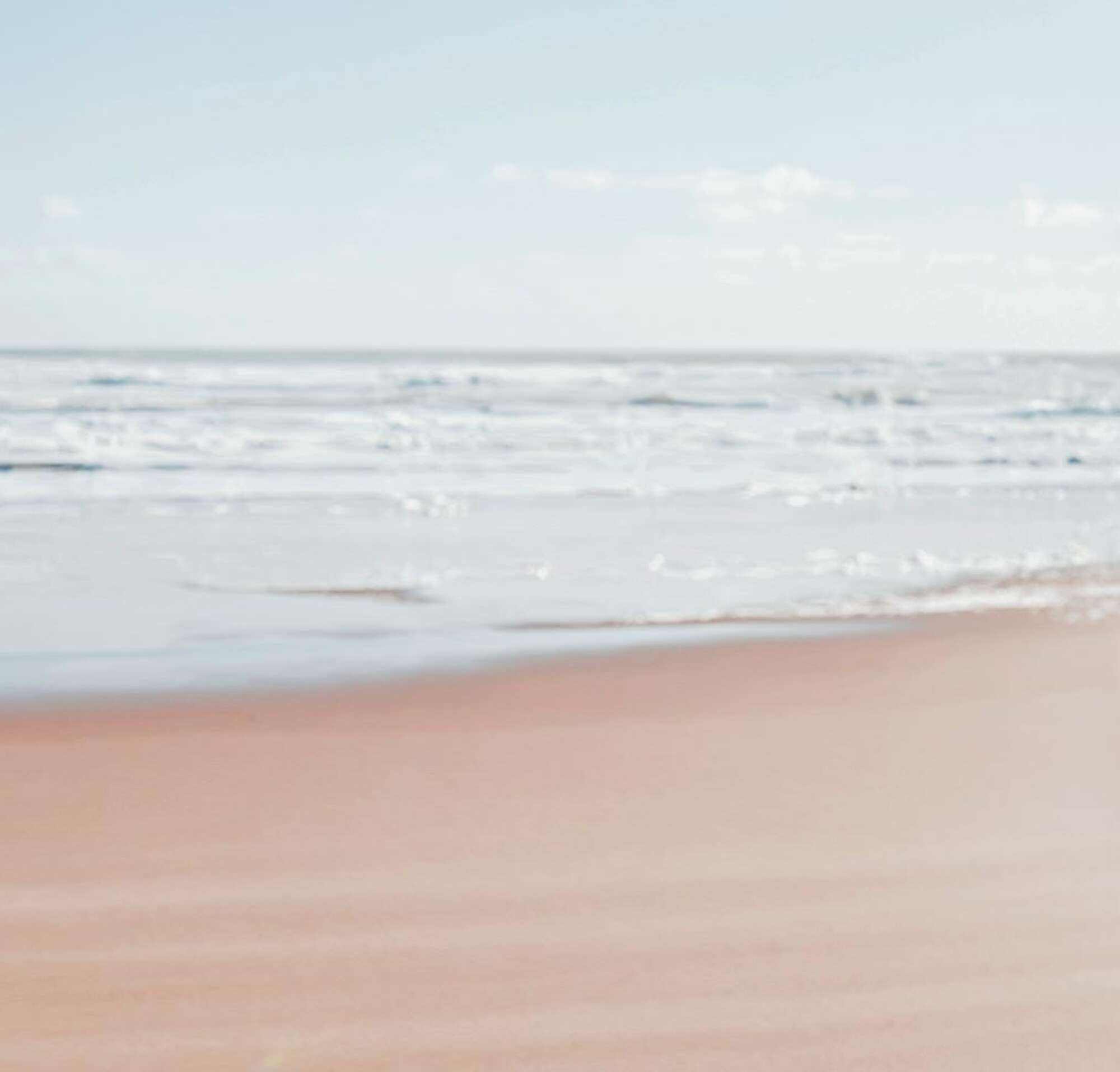 Smiling father and daughter on the beach