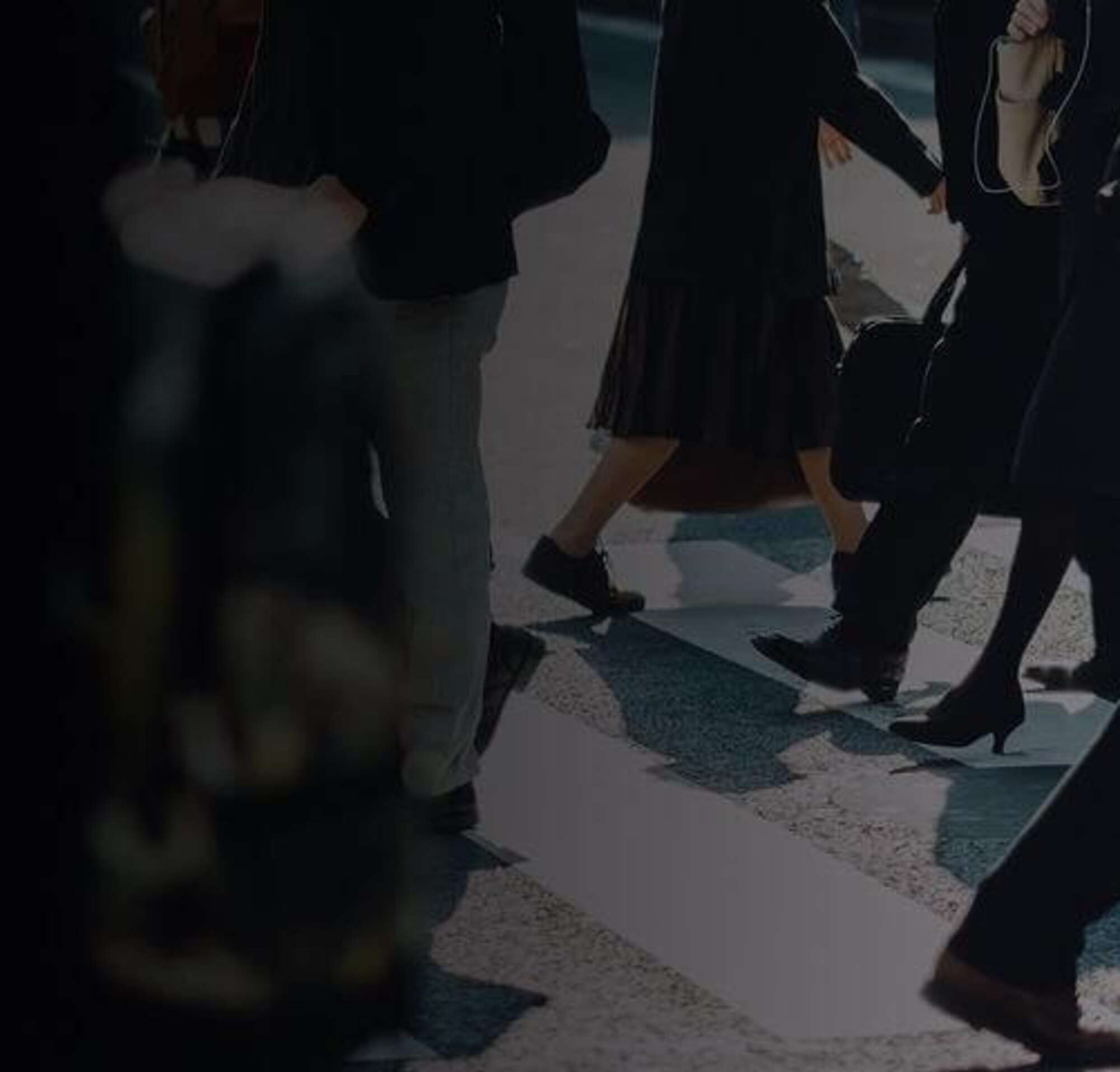 People walking in a busy crosswalk.